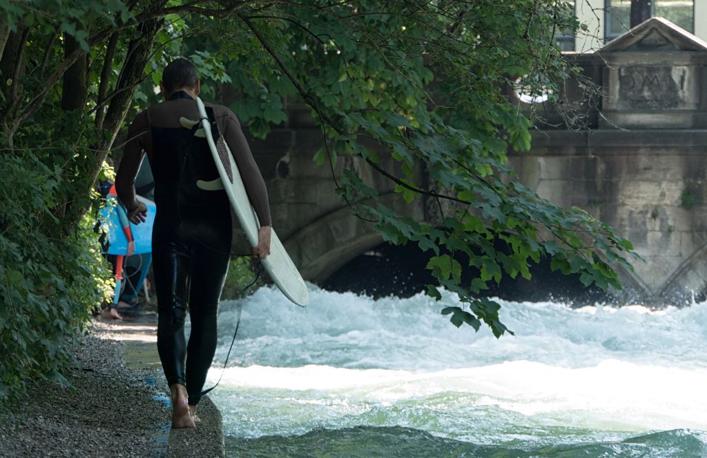 go surfing in Eisbachwelle as one of the top things to do with friends in munich germany