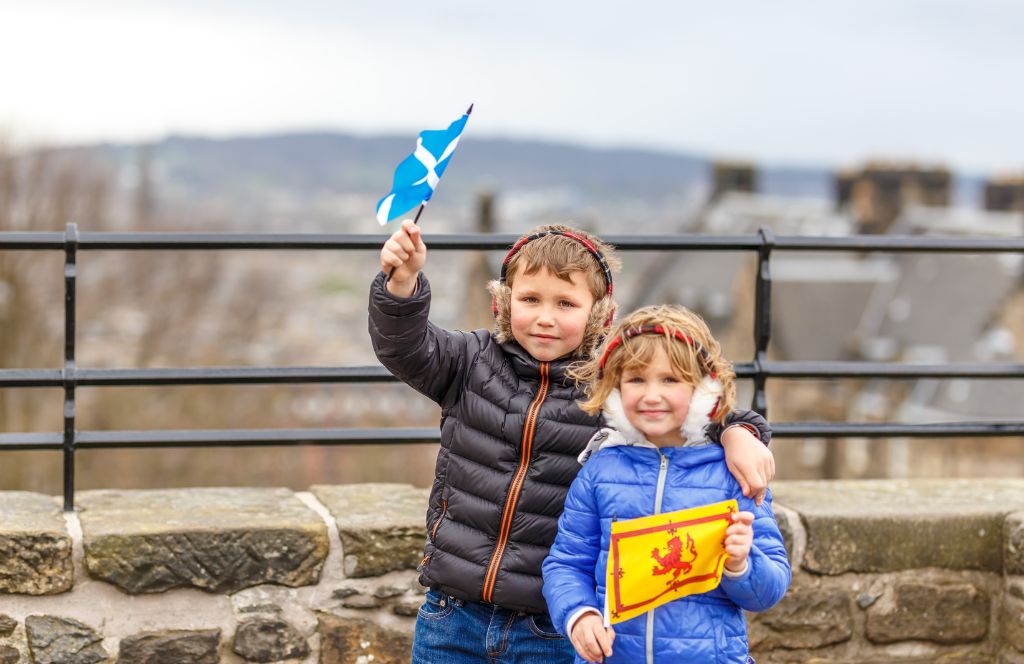 two kids in edinburgh waving a flag